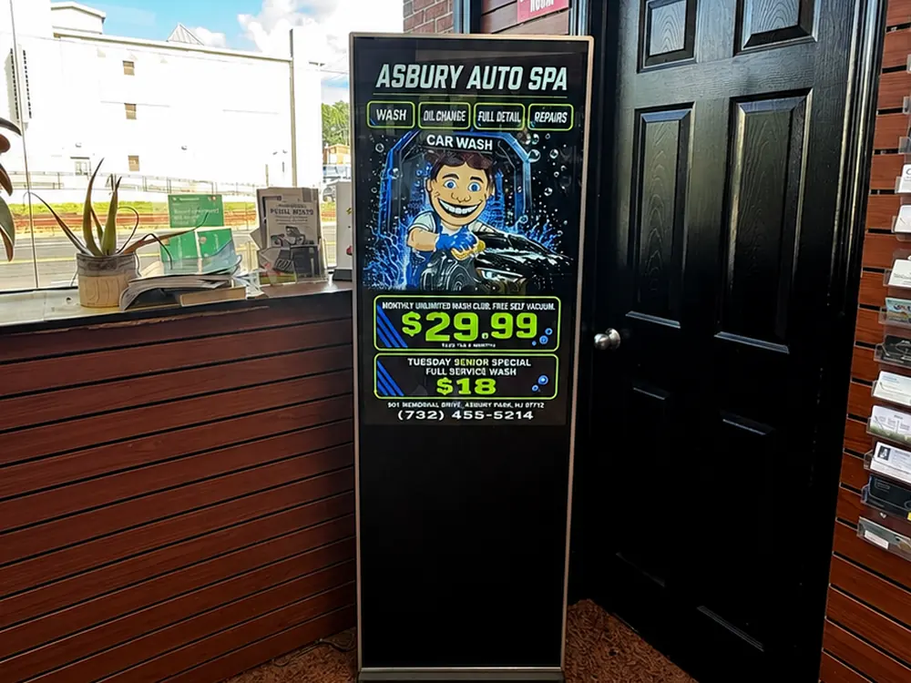 Digital Wave screen running an Asbury Auto Spa car wash ad in the lobby