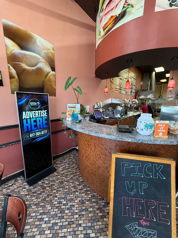 Digital Wave screen beside the counter in an Ocean Township bagel deli