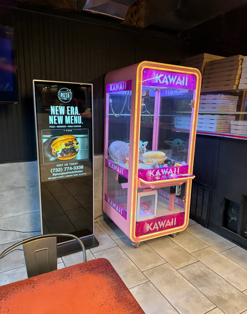 Digital Wave screen running a Pizza Plus ad inside an Asbury Park pizzeria