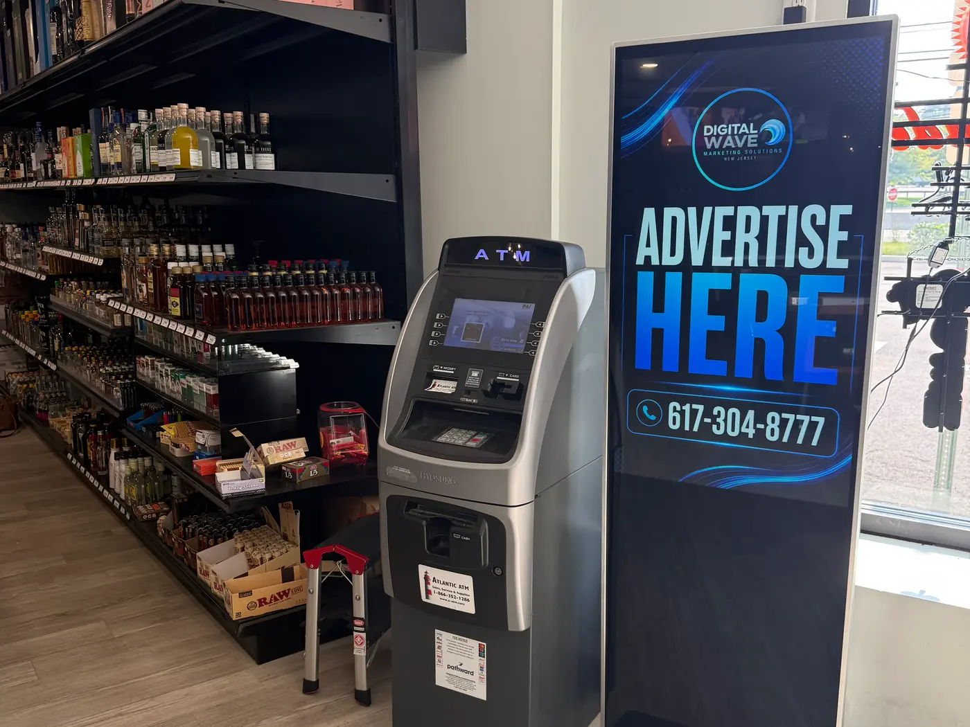 Digital Wave screen on the floor of an Ocean Township bar and liquor store